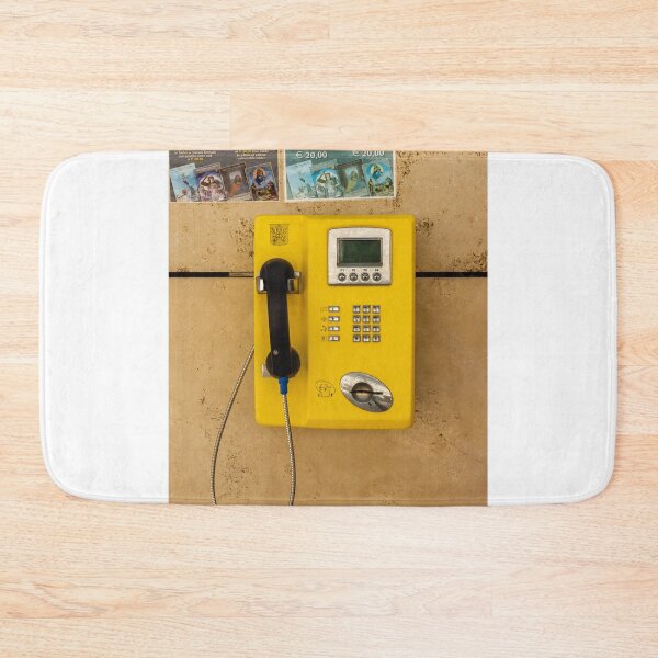 Item preview, Yellow Public Payphone Mounted on Stone Wall With Handset, Coin Slot and Tourist Posters designed and sold by Nmallia.