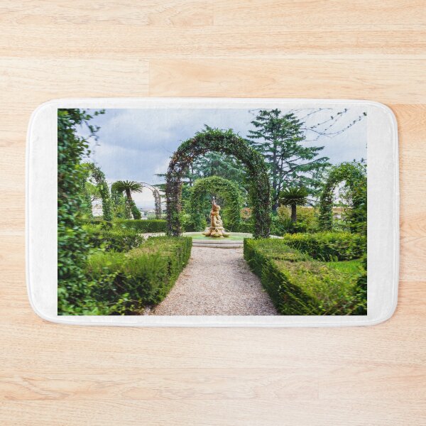 Item preview, Formal Garden Path Leading to Ornamental Fountain and Statue Through Green Arched Vines designed and sold by Nmallia.