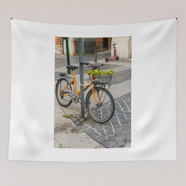 Item preview, Orange Bicycle With Flower-Filled Front Basket Locked to Pole on Cobblestone City Street designed and sold by Nmallia.