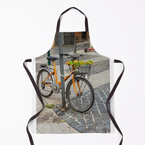Item preview, Orange Bicycle With Flower-Filled Front Basket Locked to Pole on Cobblestone City Street designed and sold by Nmallia.