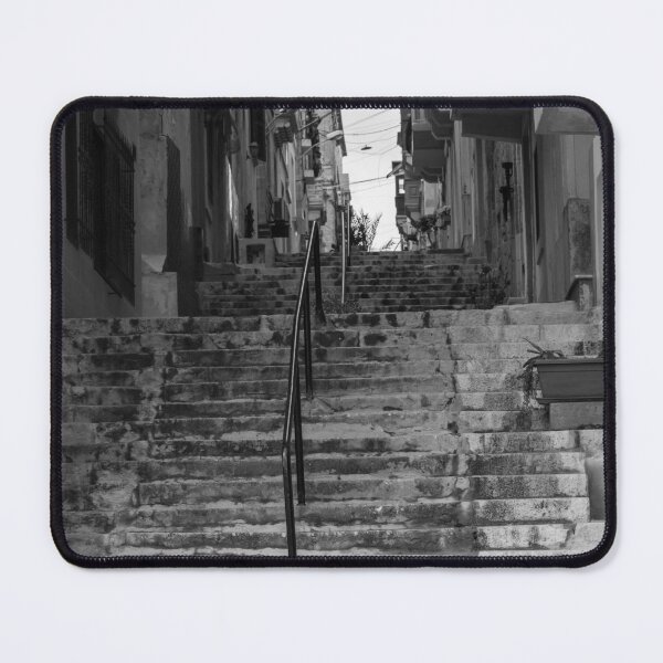 Item preview, Weathered Stone Steps With Iron Railing Beside Historic Urban Building In Monochrome designed and sold by Nmallia.