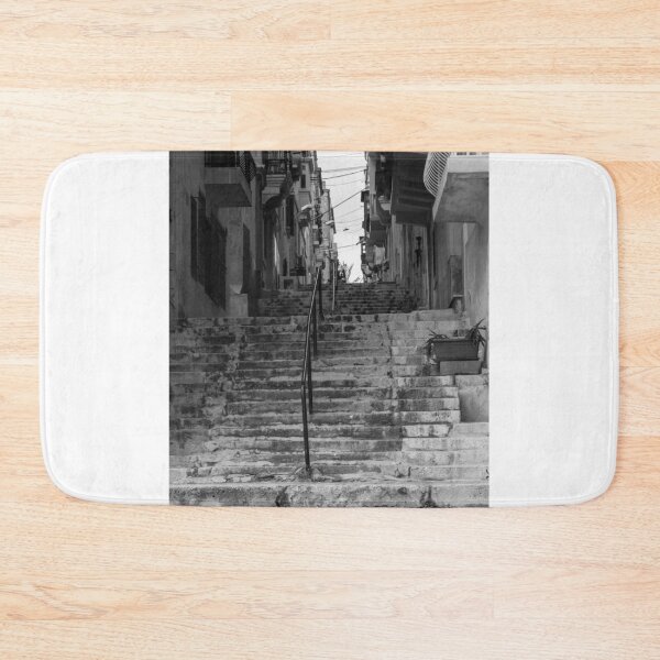 Item preview, Weathered Stone Steps With Iron Railing Beside Historic Urban Building In Monochrome designed and sold by Nmallia.