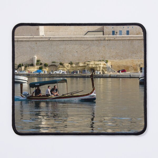 Item preview, Traditional Maltese Dgħajsa Boat Carrying Tourists Along Valletta Harbour With Limestone Fortifications designed and sold by Nmallia.