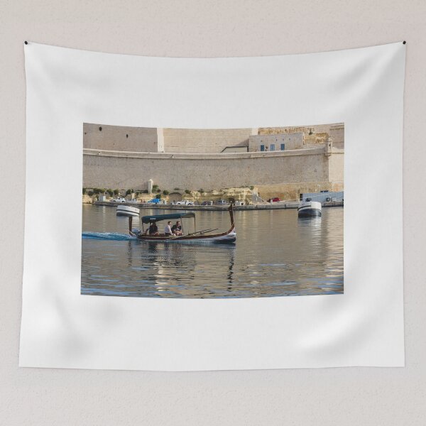 Item preview, Traditional Maltese Dgħajsa Boat Carrying Tourists Along Valletta Harbour With Limestone Fortifications designed and sold by Nmallia.