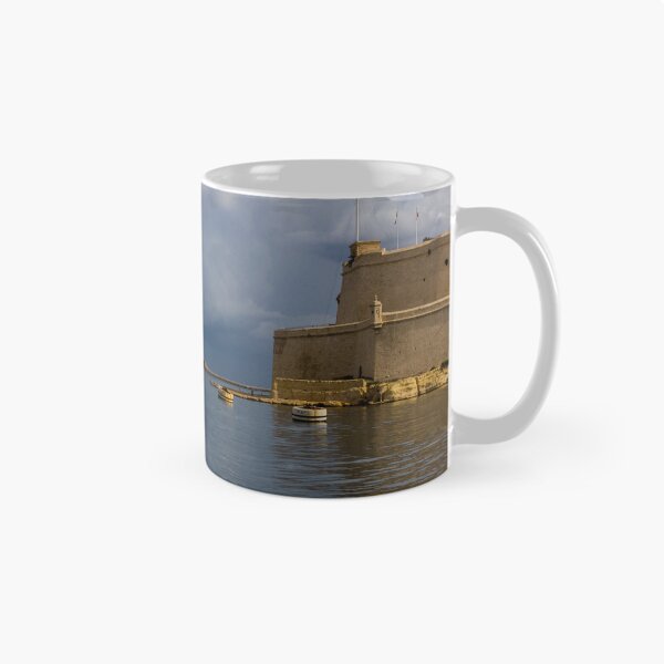 Item preview, Historic Mediterranean Harbor With Stone Fort, Calm Water and Dramatic Cloud Sky designed and sold by Nmallia.