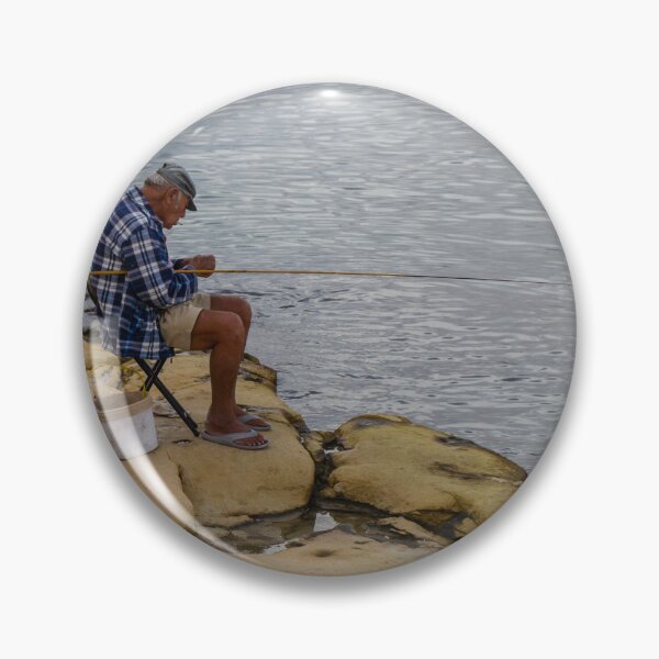Item preview, Elderly Man Fishing On Rocky Shore With Long Rod And Buckets At Calm Sea designed and sold by Nmallia.