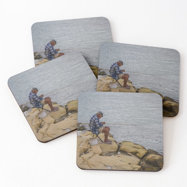 Item preview, Elderly Man Fishing On Rocky Shore With Long Rod And Buckets At Calm Sea designed and sold by Nmallia.