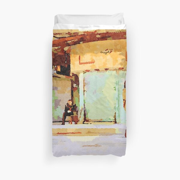 Woman and man sitting on a chair in Aleppo street Duvet Cover