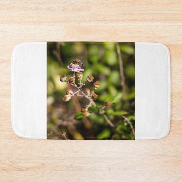 Item preview, Honey Bee Pollinating Pink Wildflower Macro Shot In Green Garden With Soft Bokeh Background designed and sold by Nmallia.