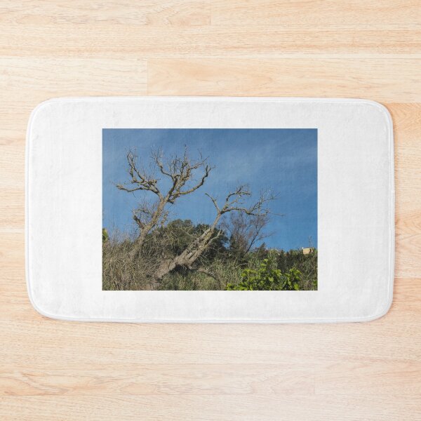 Item preview, Bare Oak Tree With Gnarled Branches Against Clear Blue Sky Over Wild Shrubland designed and sold by Nmallia.
