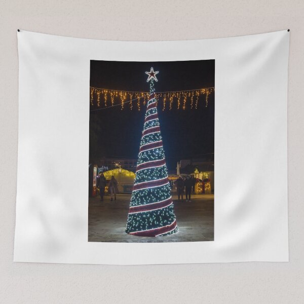 Item preview, Christmas Tree With Blue Lights In City Street At Night Surrounded By Shoppers And Festive Decorations designed and sold by Nmallia.