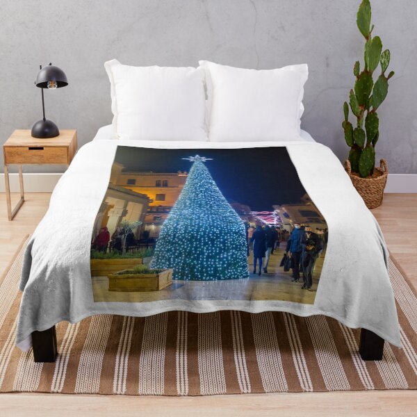 Item preview, Christmas Tree With Blue Lights In City Street At Night Surrounded By Shoppers And Festive Decorations designed and sold by Nmallia.