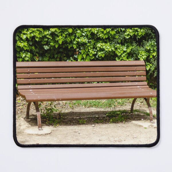 Item preview, Empty Wooden Park Bench Against Ivy Hedge in Sunny Outdoor Garden Seating Area for Relaxation designed and sold by Nmallia.