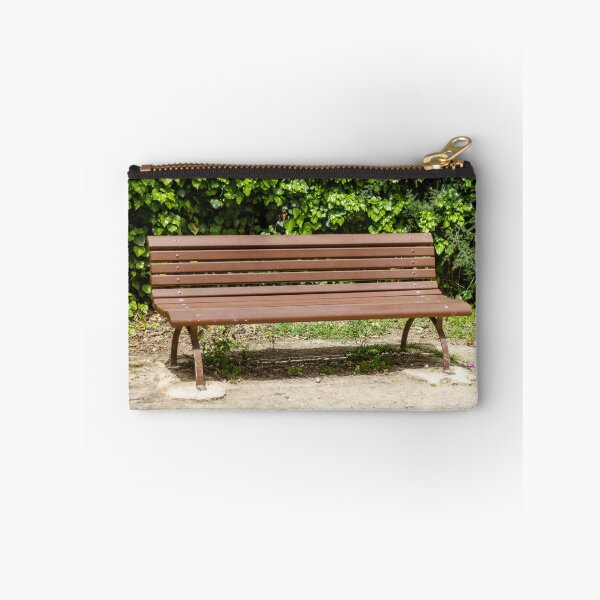 Item preview, Empty Wooden Park Bench Against Ivy Hedge in Sunny Outdoor Garden Seating Area for Relaxation designed and sold by Nmallia.