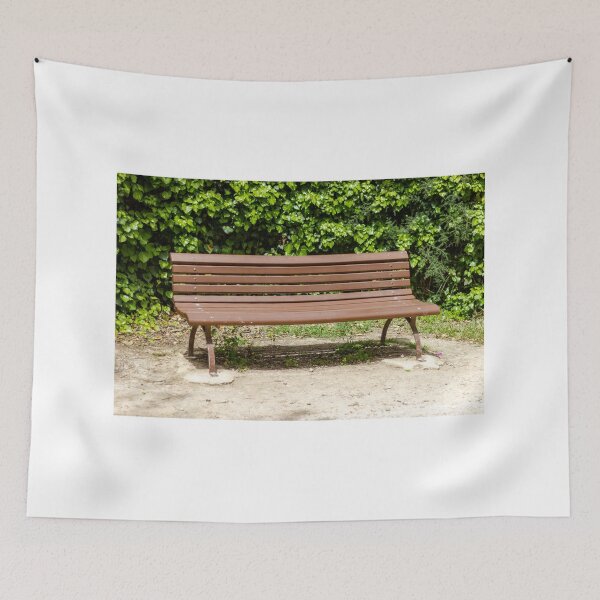 Item preview, Empty Wooden Park Bench Against Ivy Hedge in Sunny Outdoor Garden Seating Area for Relaxation designed and sold by Nmallia.