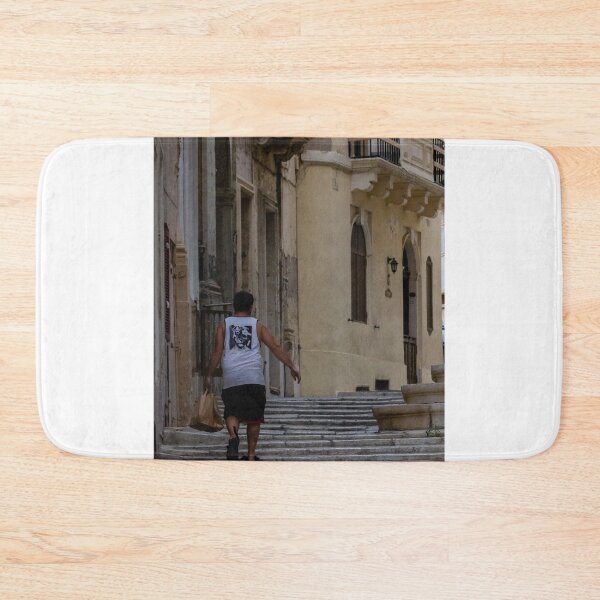 Item preview, Man Walking Up Historic Stone Steps Through Narrow Old Town Street With Warm Mediterranean Architecture designed and sold by Nmallia.