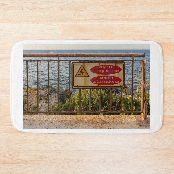 Item preview, Danger Sign On Rusty Railing Over Coastal Cliff With Sea View At Sunset designed and sold by Nmallia.