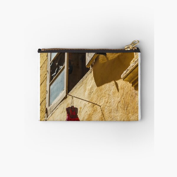 Item preview, Red Cowboy Boot Hanging From Rustic Window Above Sunlit Yellow Stucco Wall designed and sold by Nmallia.