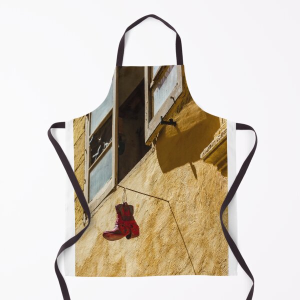 Item preview, Red Cowboy Boot Hanging From Rustic Window Above Sunlit Yellow Stucco Wall designed and sold by Nmallia.