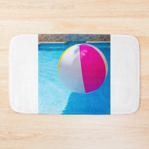 Item preview, Colorful Beach Ball Floating in Blue Swimming Pool Next to Stone Pool Deck on Sunny Day designed and sold by Nmallia.