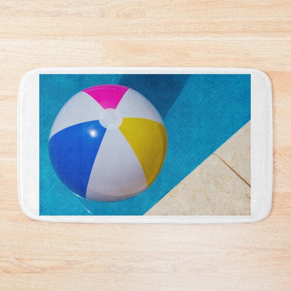 Item preview, Colorful Beach Ball Floating in Blue Swimming Pool Next to Stone Pool Deck on Sunny Day designed and sold by Nmallia.