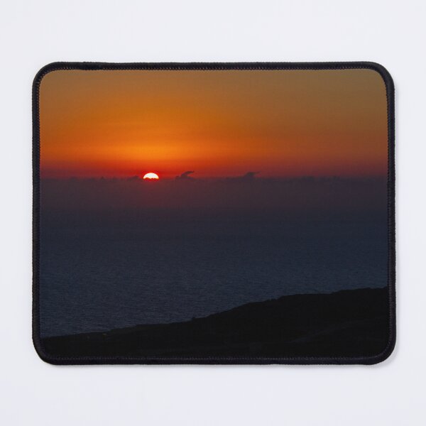 Item preview, Dramatic Orange Sunset Over Calm Ocean Horizon With Silhouetted Coastal Landscape At Dusk designed and sold by Nmallia.