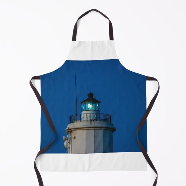 Item preview, Coastal Lighthouse Beacon Tower Illuminated At Dusk Against Deep Blue Evening Sky Over Ocean designed and sold by Nmallia.