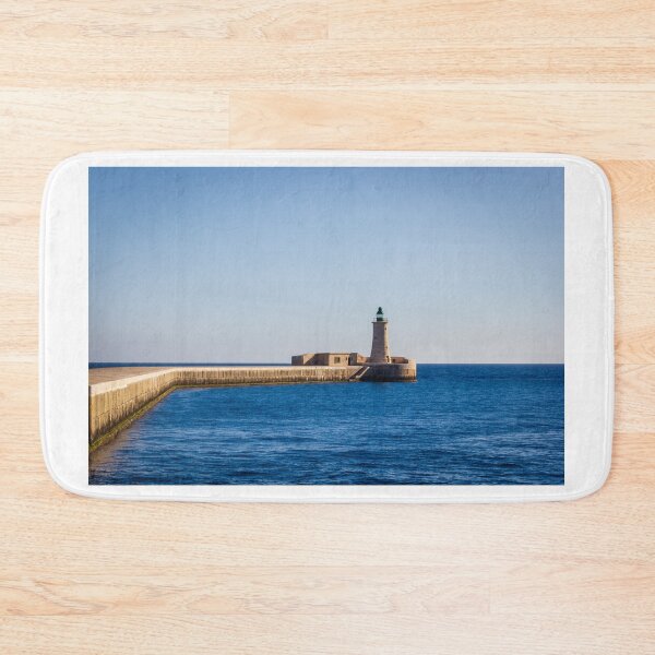 Item preview, Lighthouse on a Stone Pier Over Calm Blue Sea Under Clear Sky at Coastal Breakwater designed and sold by Nmallia.