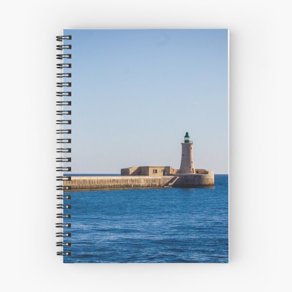 Item preview, Lighthouse on a Stone Pier Over Calm Blue Sea Under Clear Sky at Coastal Breakwater designed and sold by Nmallia.