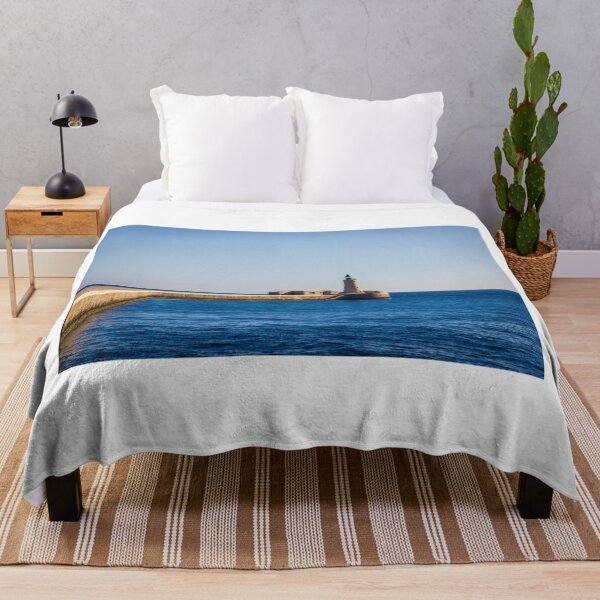Item preview, Lighthouse on a Stone Pier Over Calm Blue Sea Under Clear Sky at Coastal Breakwater designed and sold by Nmallia.