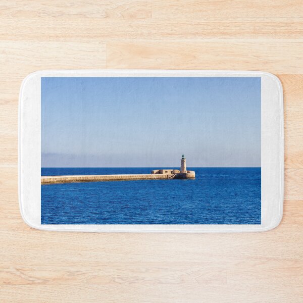 Item preview, Lighthouse on a Stone Pier Over Calm Blue Sea Under Clear Sky at Coastal Breakwater designed and sold by Nmallia.