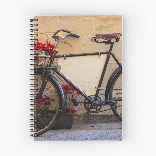 Item preview, Vintage Bicycle With Wicker Basket of Red Poinsettias Leaning Against Rustic Wall on Street designed and sold by Nmallia.