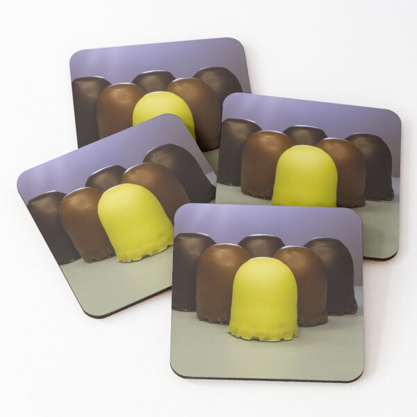 Item preview, Yellow Candy Standing Out Among Chocolate-Coated Confections On Gray Surface With Soft Lighting designed and sold by Nmallia.