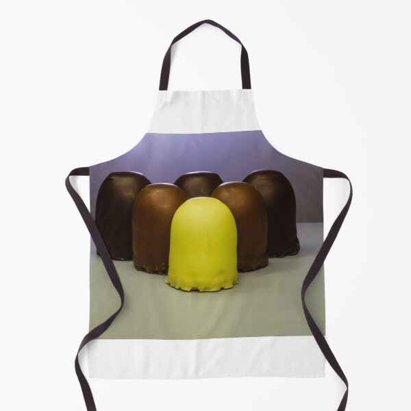 Item preview, Yellow Candy Standing Out Among Chocolate-Coated Confections On Gray Surface With Soft Lighting designed and sold by Nmallia.