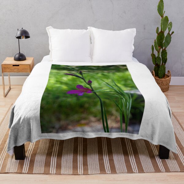 Item preview, Purple Wildflower Blooming Among Green Grass With Soft Bokeh Background In Spring Garden designed and sold by Nmallia.