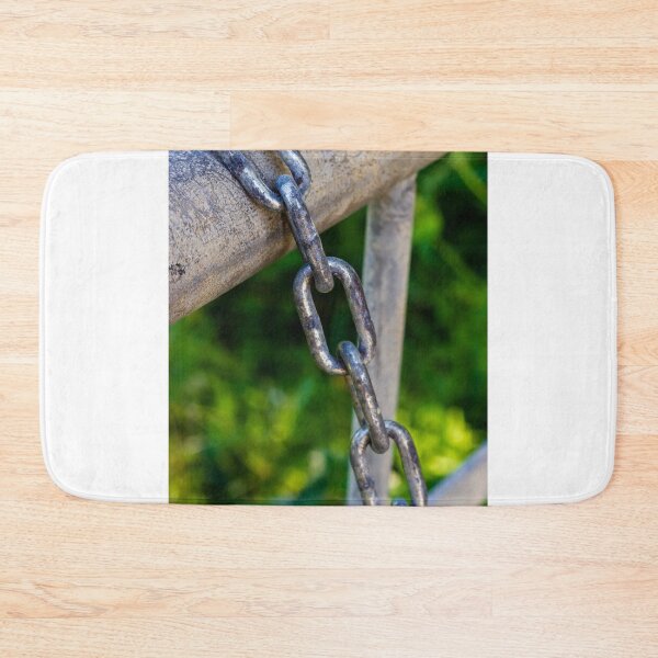 Item preview, Weathered Metal Chain Links Hanging From Gate Rail With Rusted Texture And Green Background designed and sold by Nmallia.