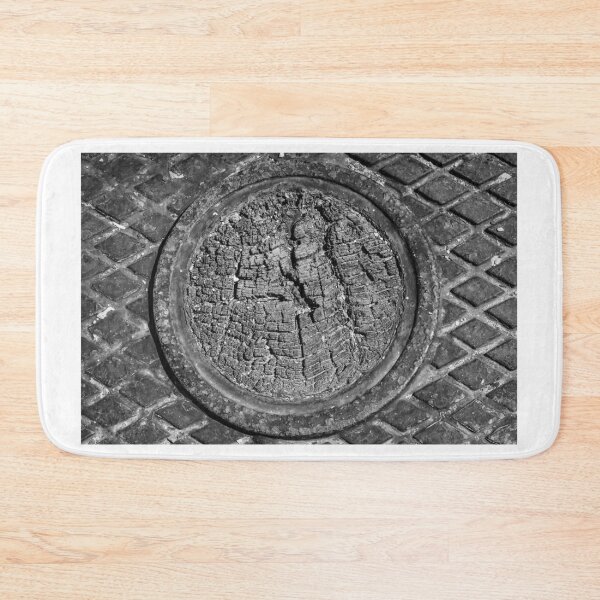 Item preview, Weathered Tree Ring Manhole Cover in Metal Grid Pavement, Black and White Texture Close-Up designed and sold by Nmallia.