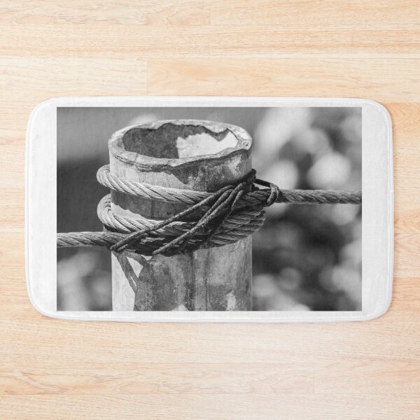 Item preview, Close-Up of Steel Cable and Rope Wrapped Around Weathered Mooring Post in Black and White designed and sold by Nmallia.