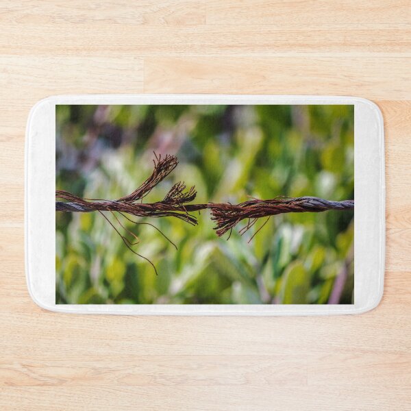Item preview, Close-Up Of Frayed Rusty Wire Rope Breaking Under Tension Against Green Blurred Background designed and sold by Nmallia.