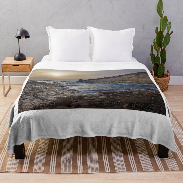 Item preview, Sunset Over Rocky Coastline With Waves, Cliff Fort And Distant Lighthouse On Calm Sea designed and sold by Nmallia.
