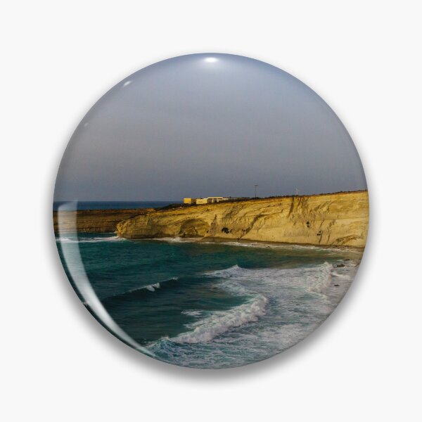Item preview, Golden Coastal Cliffs Over Turquoise Sea With Waves Crashing Along A Remote Rocky Shoreline designed and sold by Nmallia.