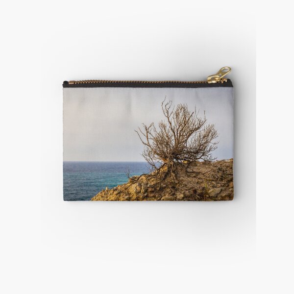 Item preview, Lonely Coastal Shrub Clinging to Rocky Cliff Overlooking Turquoise Sea at Sunset designed and sold by Nmallia.