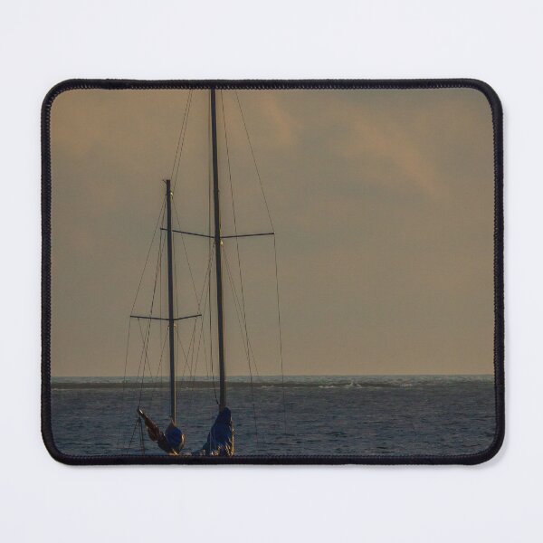Item preview, Sailboat Anchored At Sea During Golden Sunset With Calm Waters And Dramatic Sky designed and sold by Nmallia.