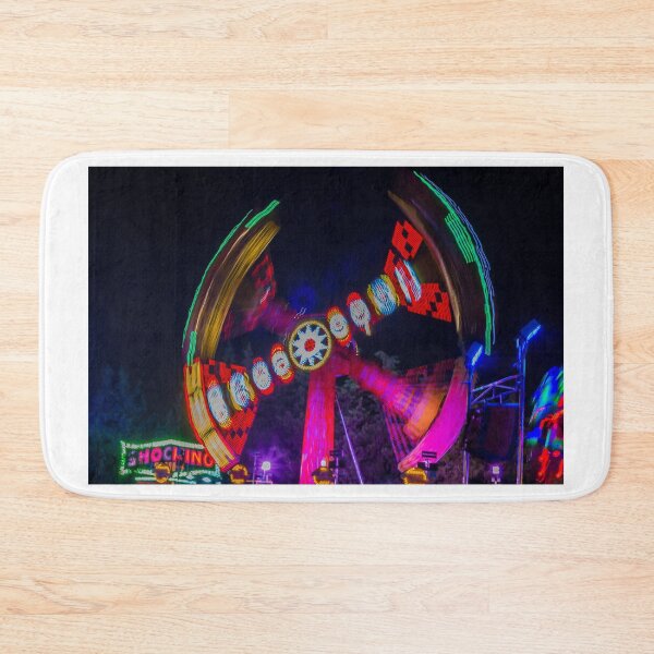 Item preview, Spinning Carnival Ride At Night With Colorful Lights And Motion Blur At An Amusement Park Fair designed and sold by Nmallia.