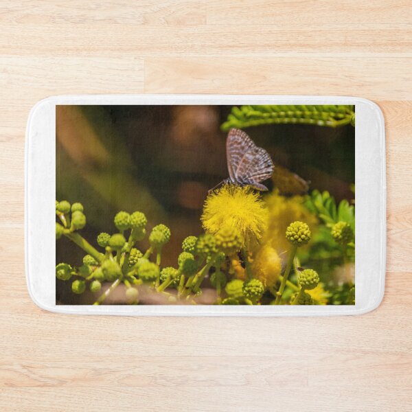 Item preview, Small Blue Butterfly Feeding on Bright Yellow Puff Flower Among Green Buds in Natural Macro designed and sold by Nmallia.