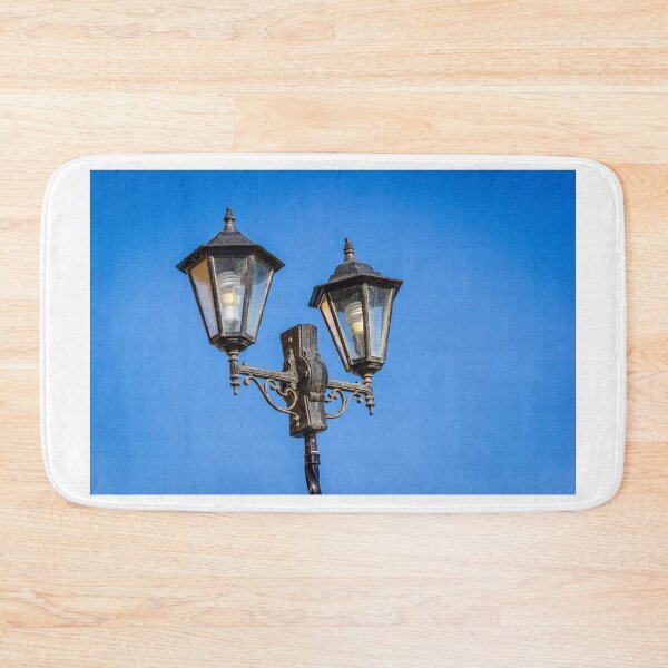 Item preview, Vintage Double Street Lamp With Glass Lanterns Against Clear Blue Sky designed and sold by Nmallia.