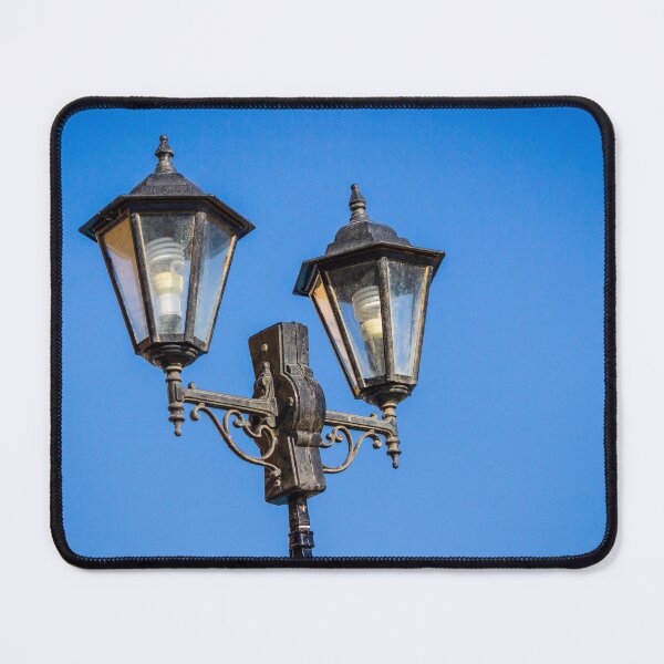 Item preview, Vintage Double Street Lamp With Glass Lanterns Against Clear Blue Sky designed and sold by Nmallia.