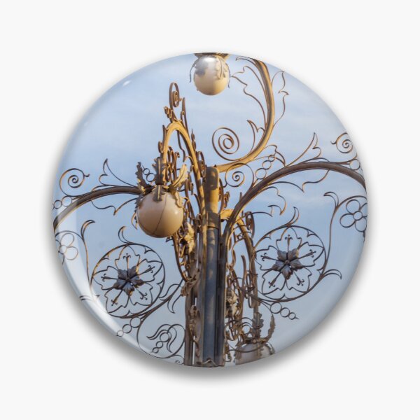 Item preview, Ornate Decorative Street Lamp With Floral Metalwork and Globe Lights Against Blue Sky designed and sold by Nmallia.