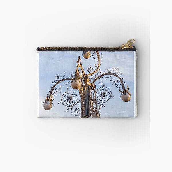 Item preview, Ornate Decorative Street Lamp With Floral Metalwork and Globe Lights Against Blue Sky designed and sold by Nmallia.