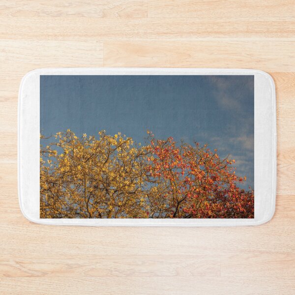 Item preview, Golden and Pink Flowering Trees Against Blue Sky at Sunset With Warm Light designed and sold by Nmallia.
